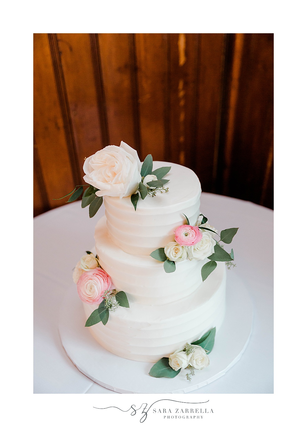 tiered wedding cake with pink flowers