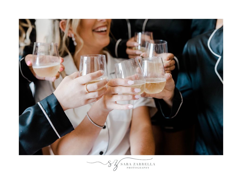 bride and bridesmaids toast with champagne 