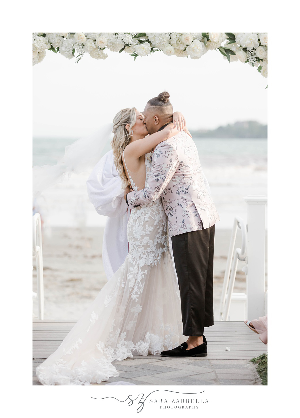 newlyweds kiss in aisle at Newport Beach House