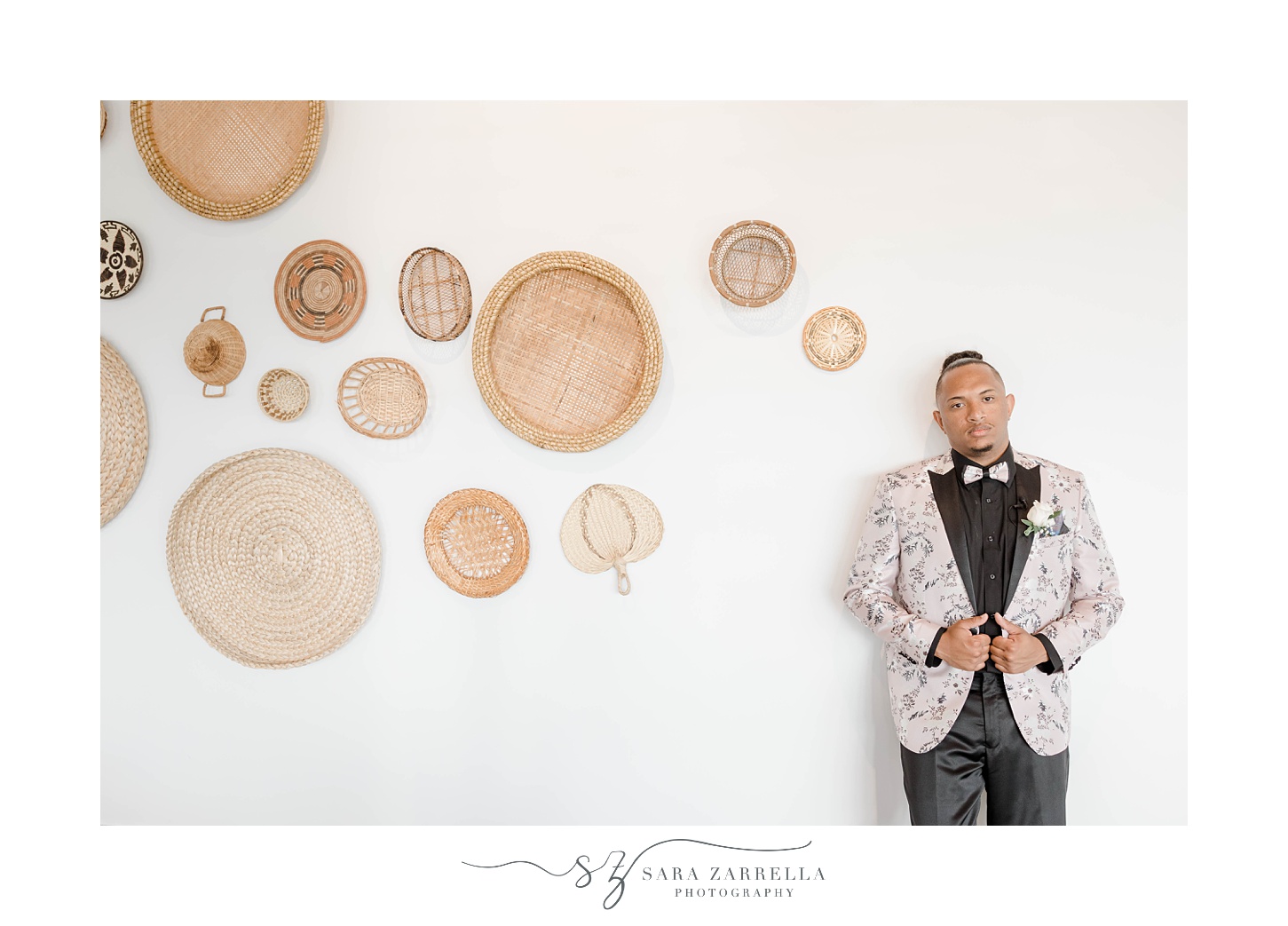 groom poses by woven basket display at Newport Beach House