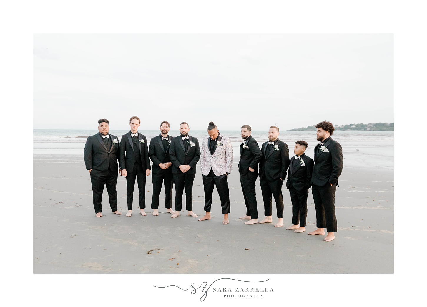 groom and groomsmen stand barefoot on sand in Newport RI