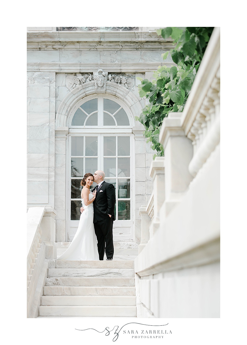 newlyweds pose on staircase in Newport RI