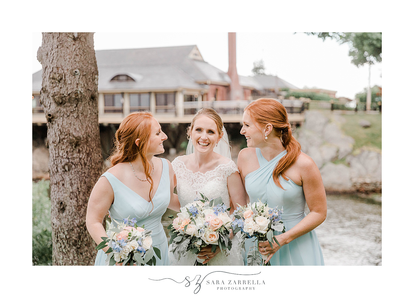 bride laughs with sisters in light blue gowns at Squantum Association