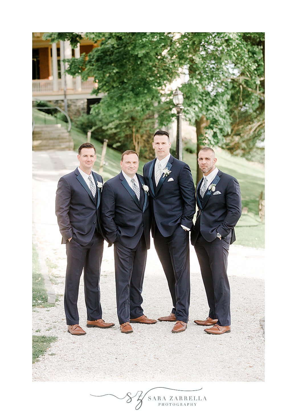 groom stands with groomsmen in navy suits at Squantum Association