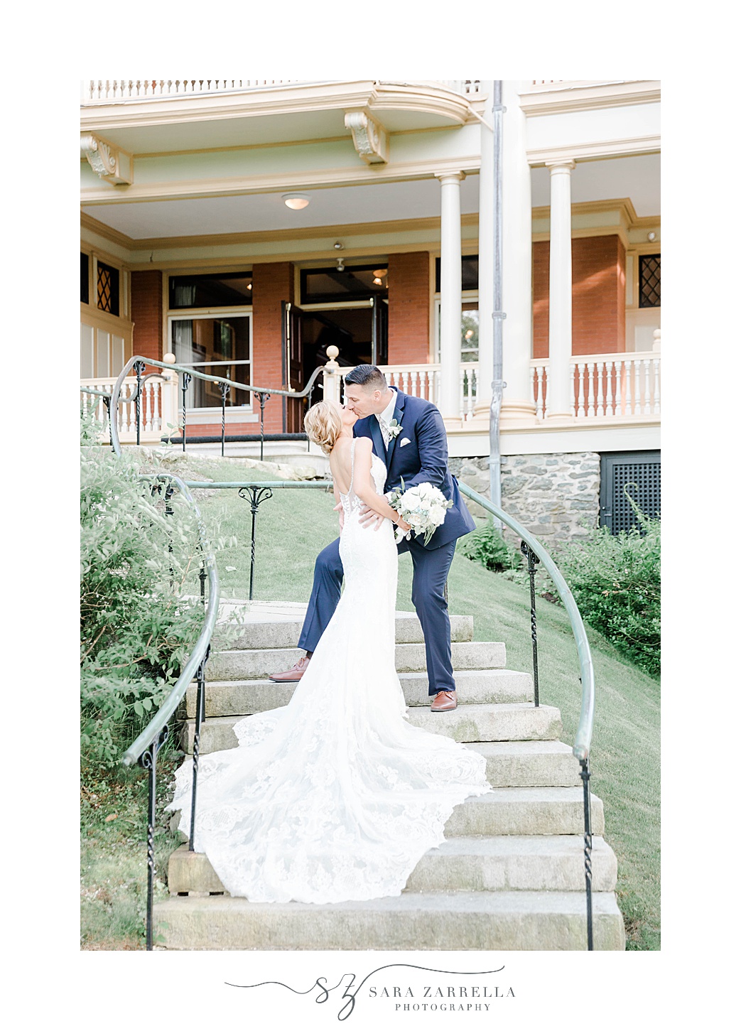 newlyweds kiss on steps at Squantum Association