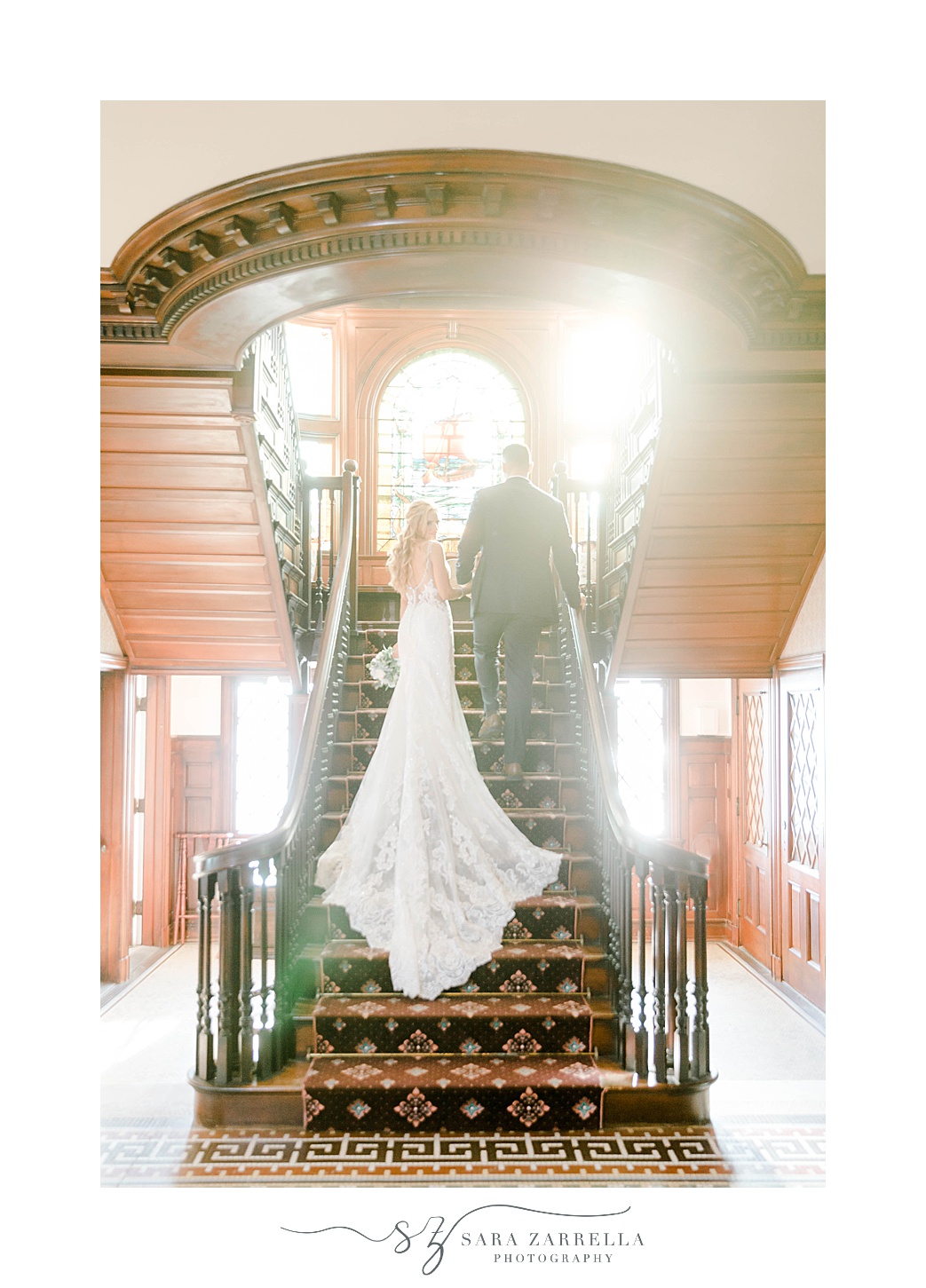 bride and groom walk up staircase at Squantum Association