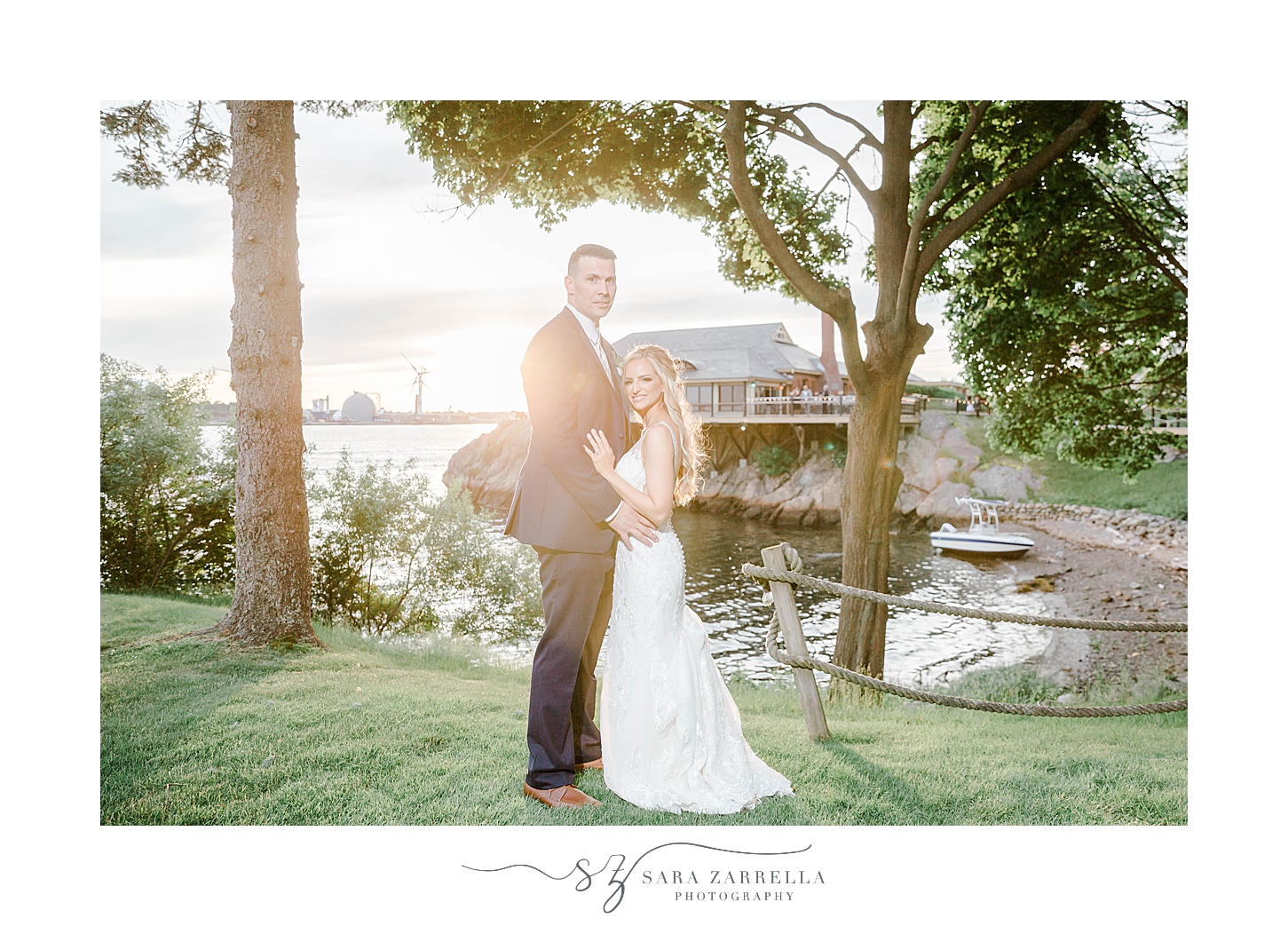 bride and groom hug at sunset at Squantum Association