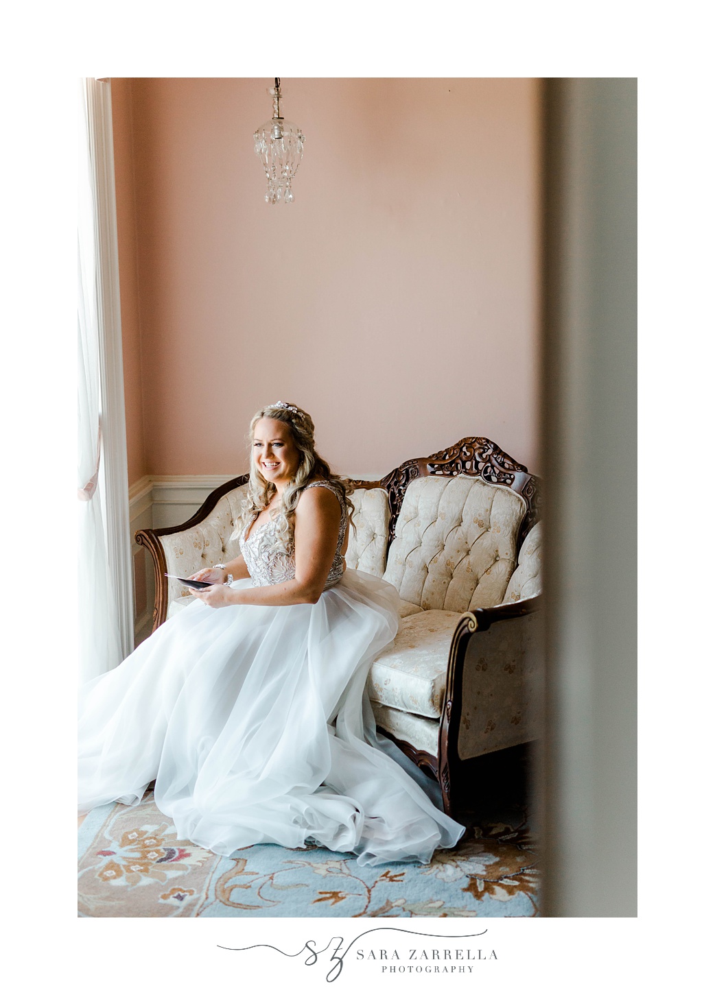 bride sits on ivory couch before Aldrich Mansion wedding