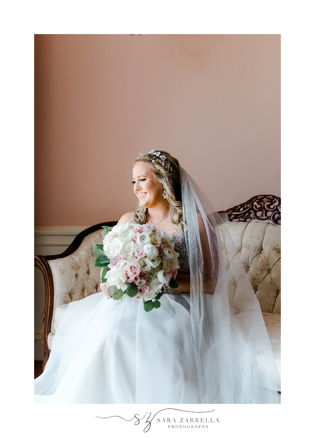 bride sits on ivory and wood couch before Aldrich Mansion wedding