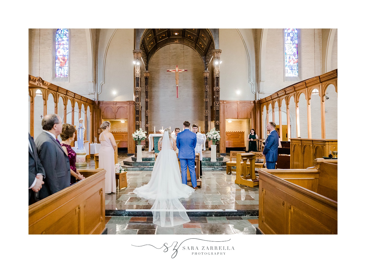 bride and groom stand at alter during traditional wedding ceremony in Rhode Island church
