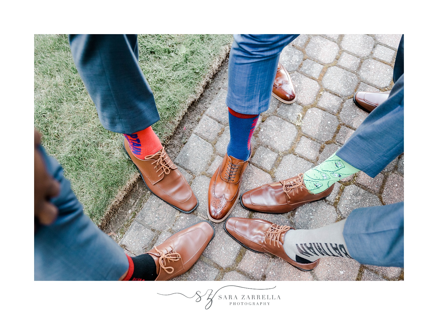 groom shows off socks with groomsmen on pathway at Aldrich Mansion