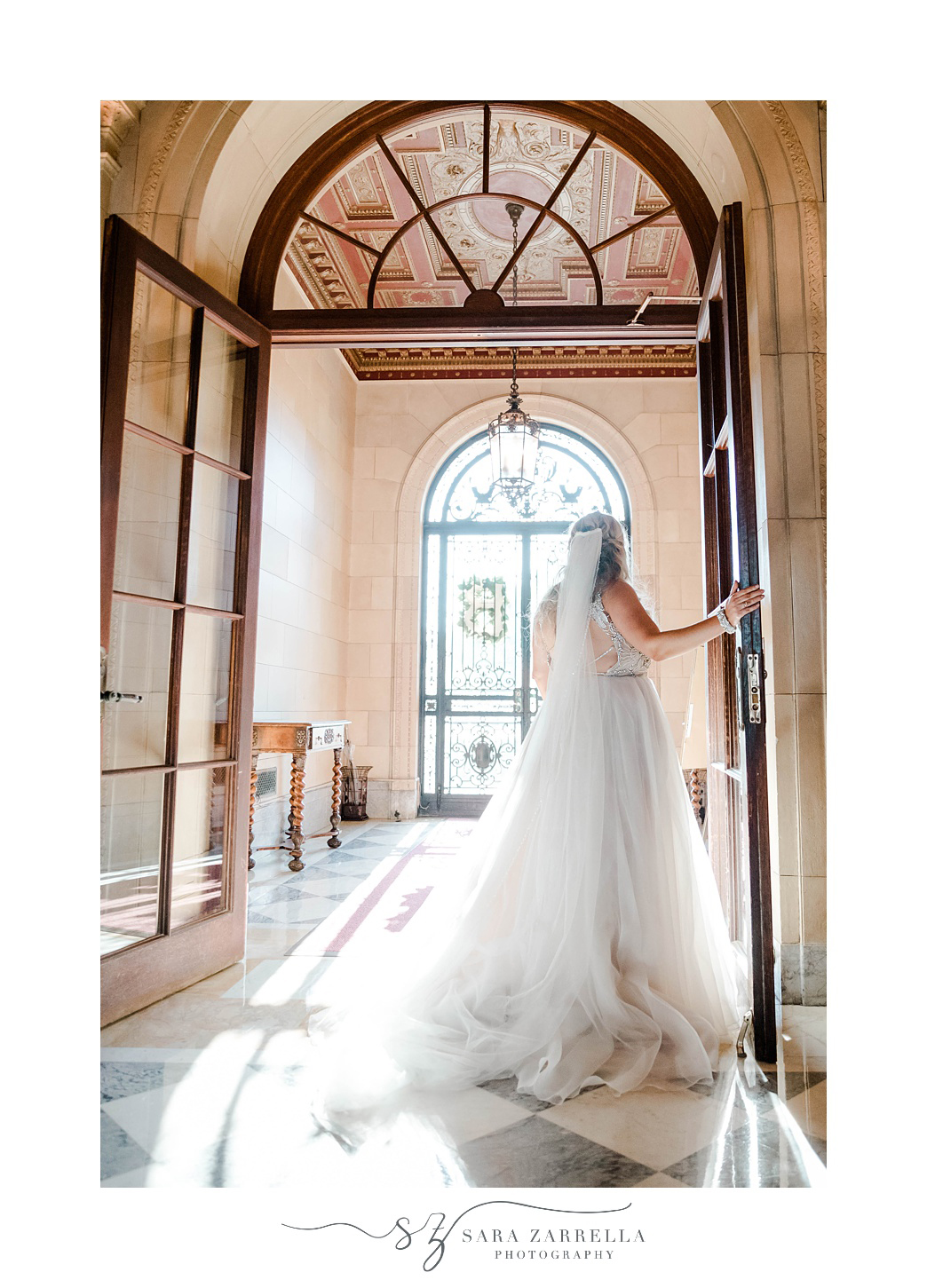 bride poses in doorframe of Aldrich Mansion