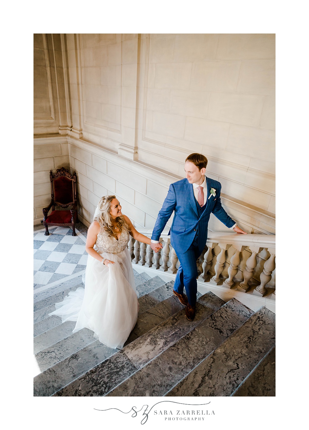 bride and groom hold hands walking up steps inside Aldrich Mansion