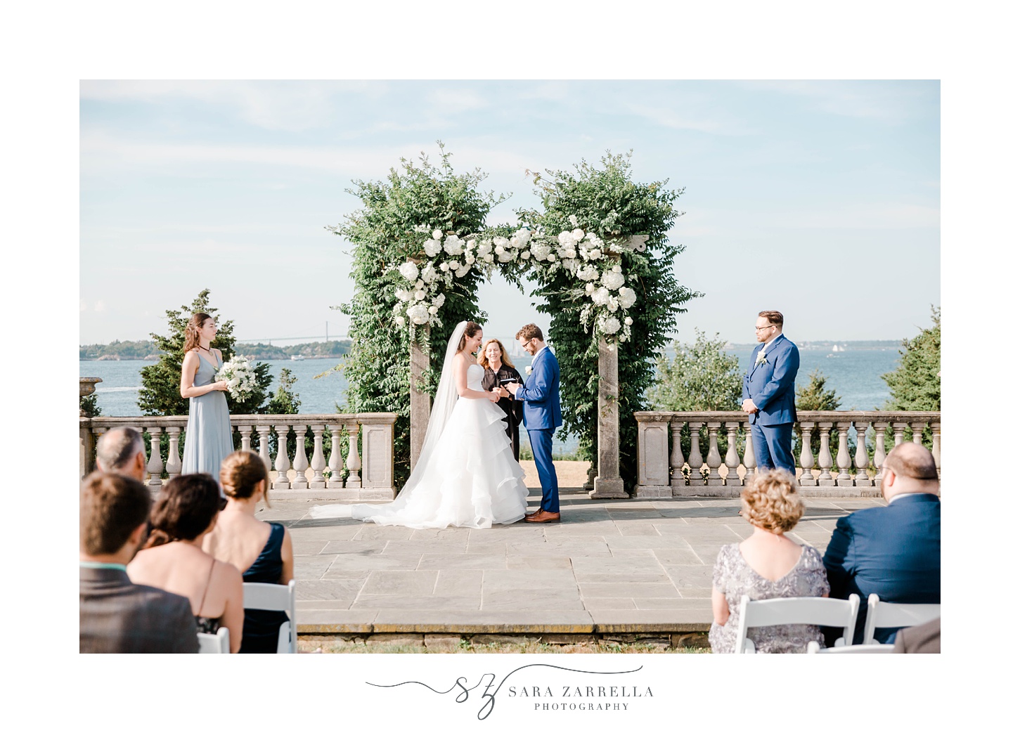 bride and groom stand under arch at Castle Hill Inn