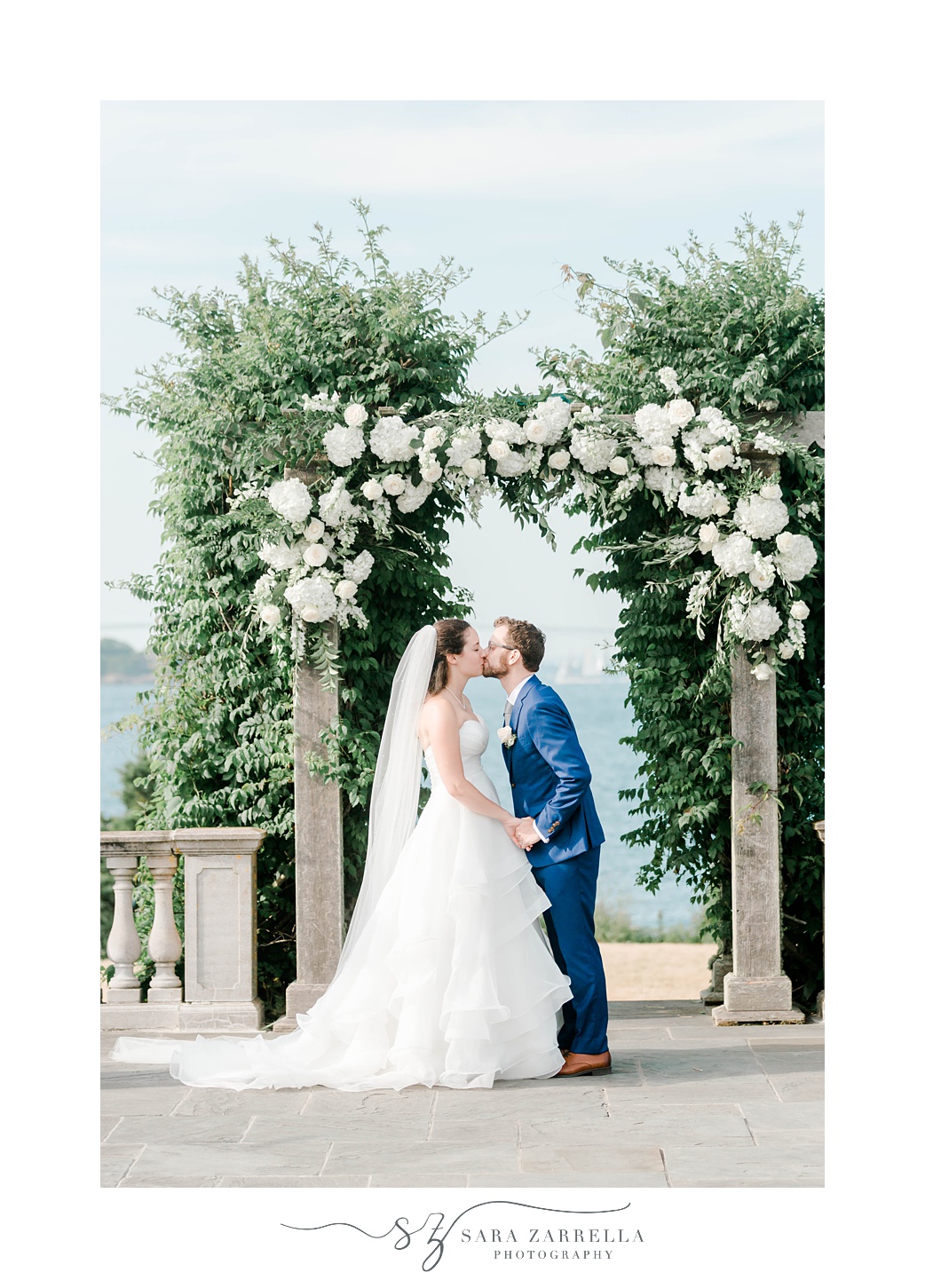 newlyweds kiss after ceremony at Castle Hill Inn