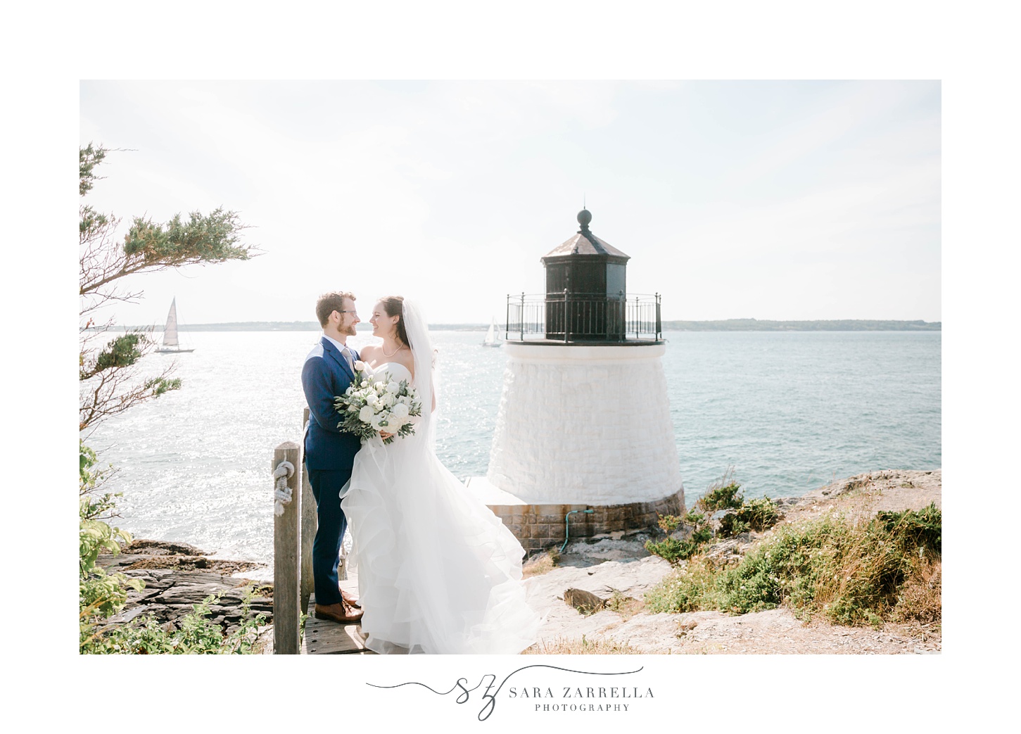 bride and groom hug near lighthouse 