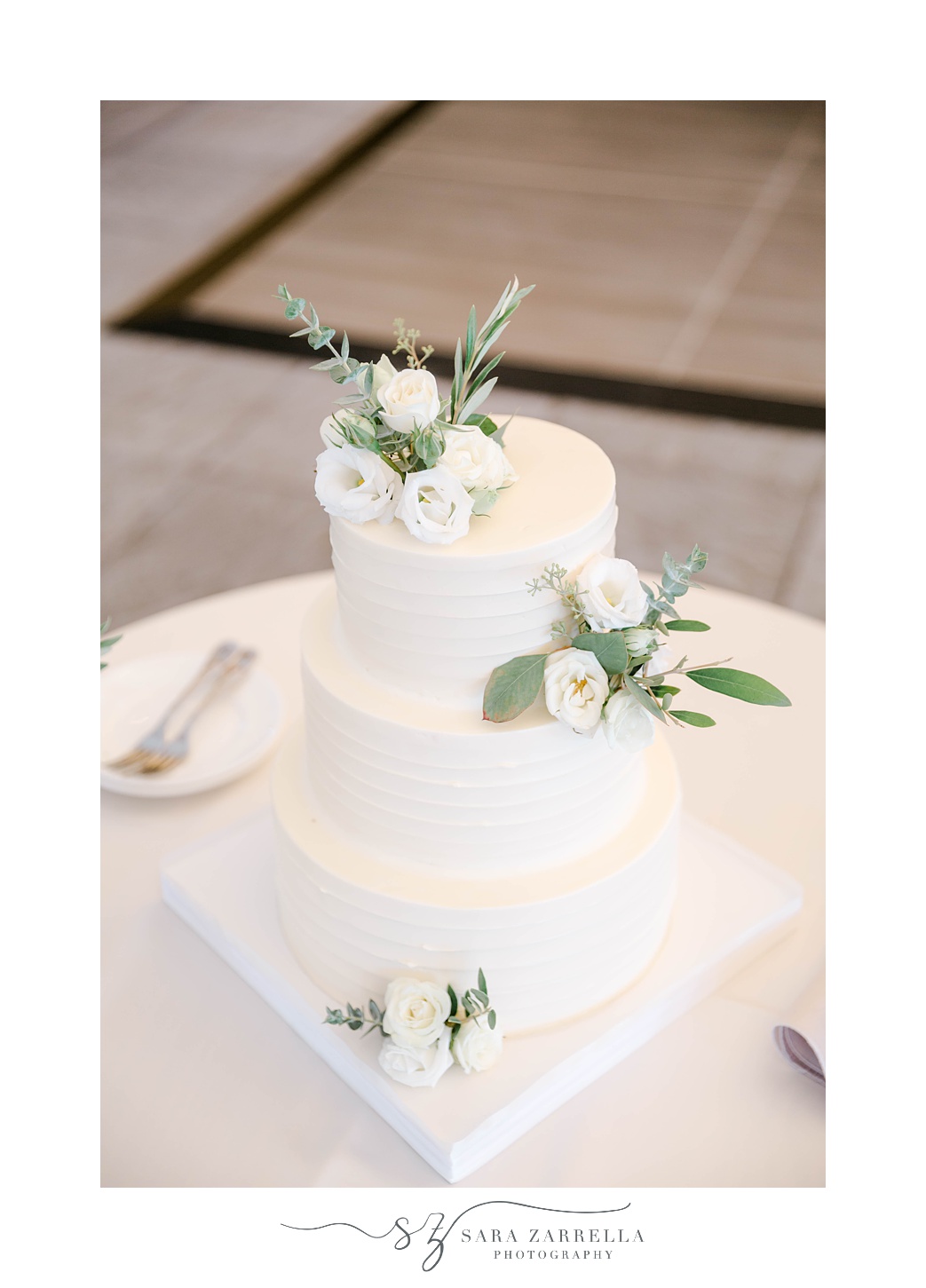 tiered wedding cake with white flower details 