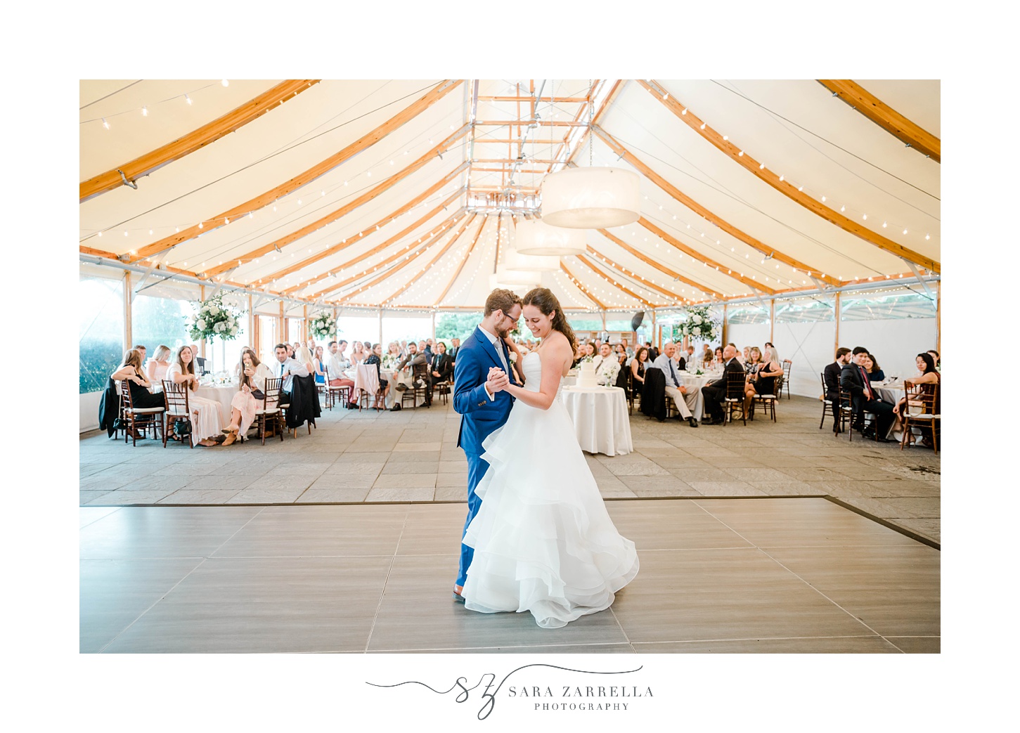 bride and groom dance during tented wedding reception 
