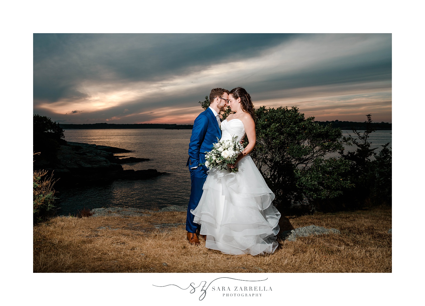bride and groom kiss at sunset at Castle Hill Inn