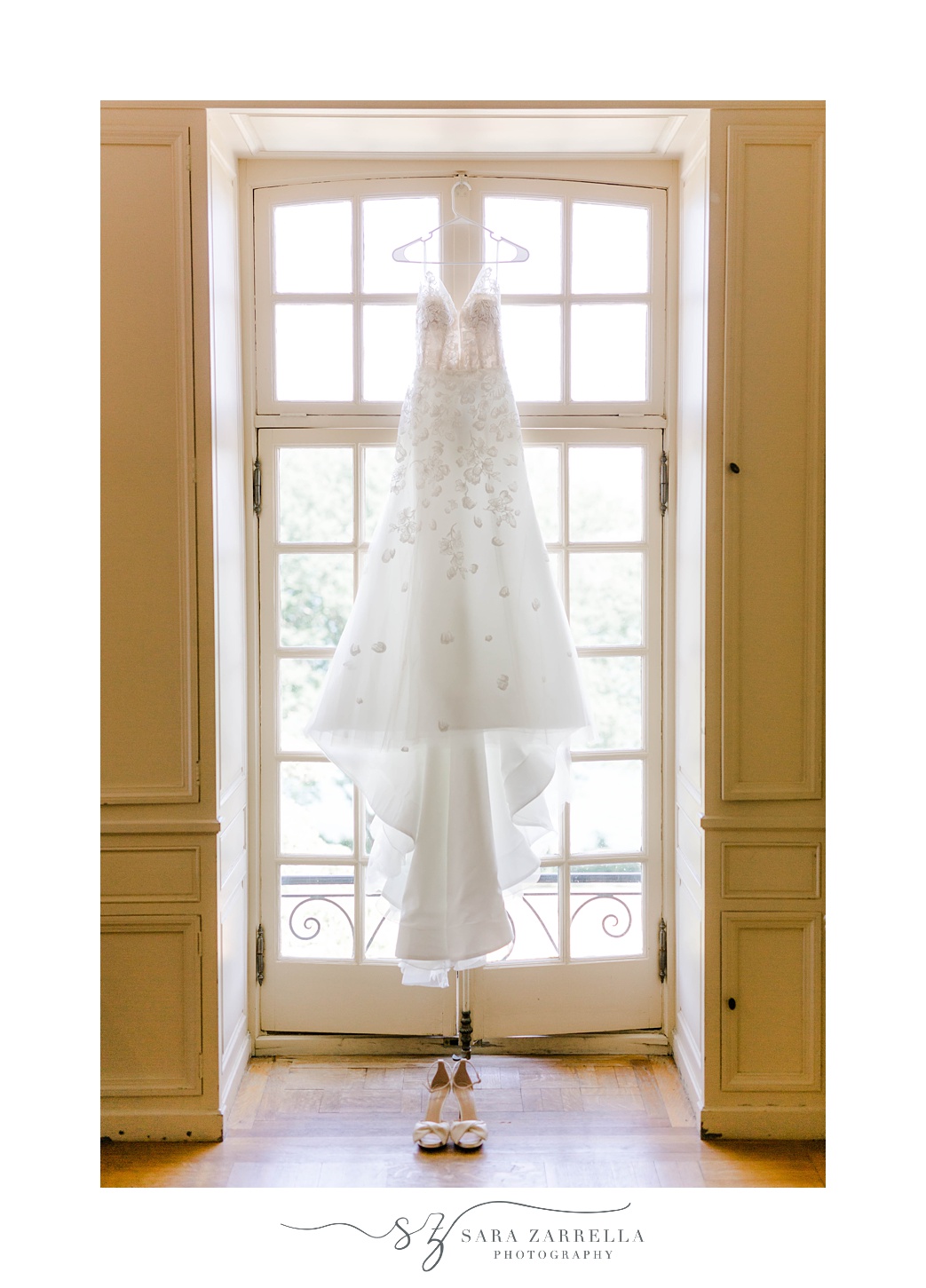 bride's dress hangs in window before Glen Manor House wedding