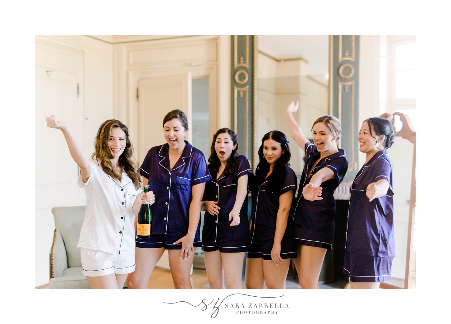 bride pops champagne with bridesmaids 