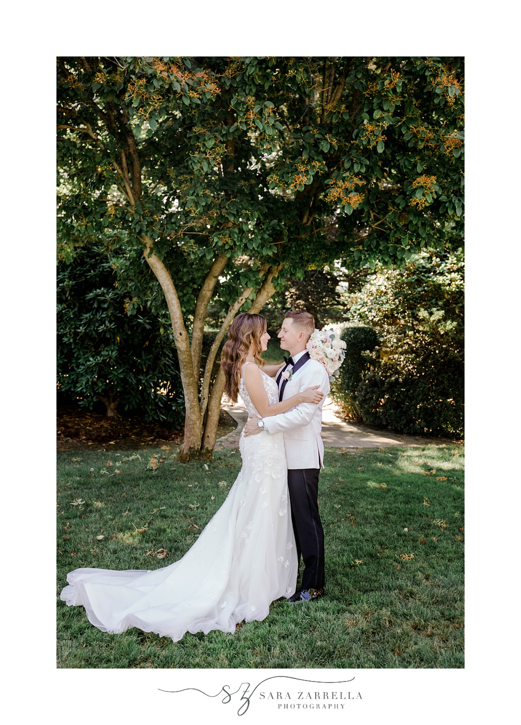 bride and groom hug by tree at Glen Manor House