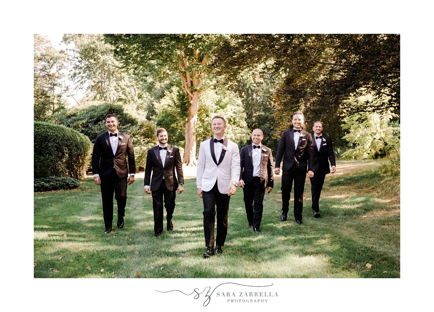 groom in white tux jacket walks with groomsmen at Glen Manor House
