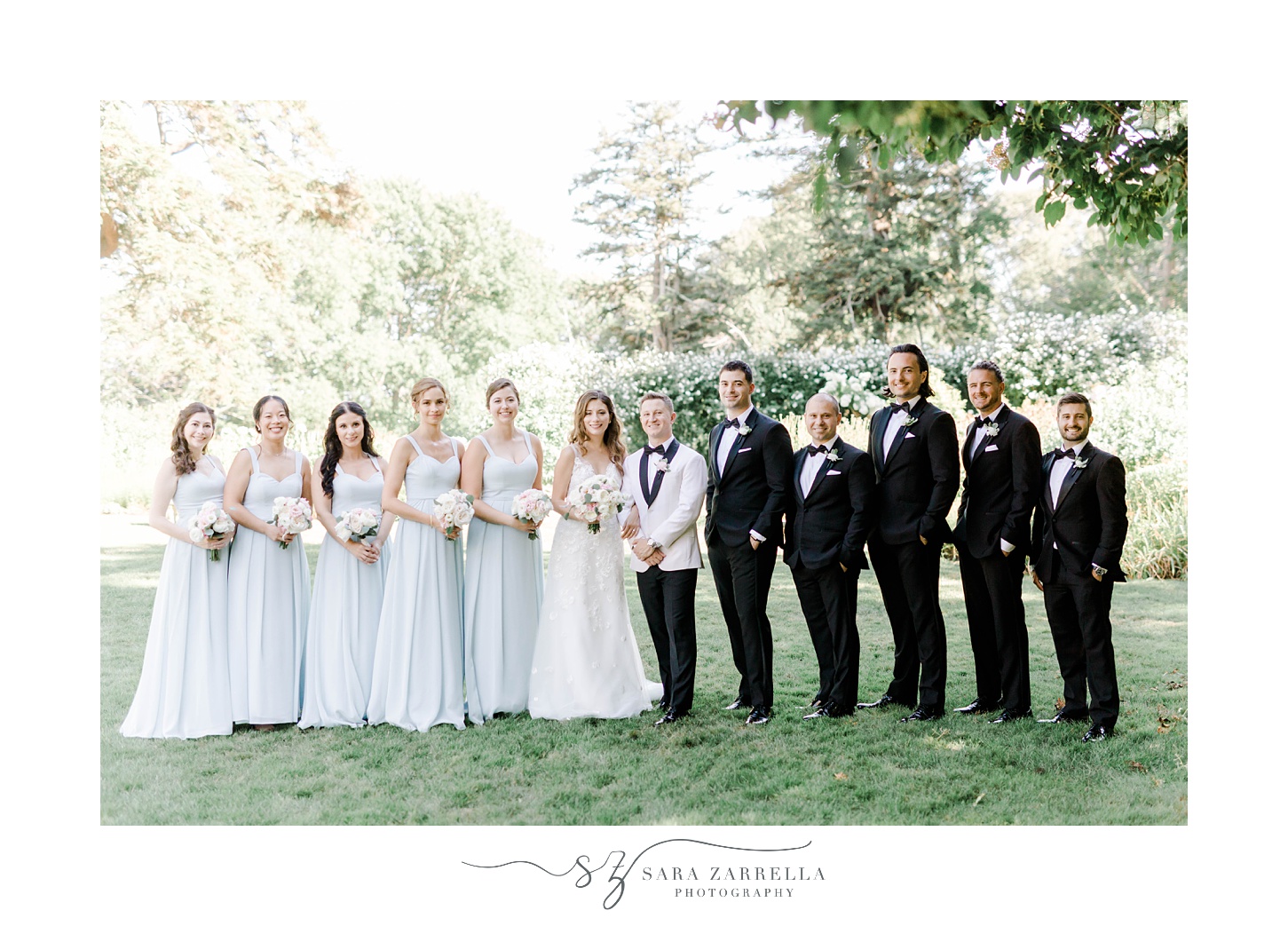 bride and groom stand together with wedding party at Glen Manor House