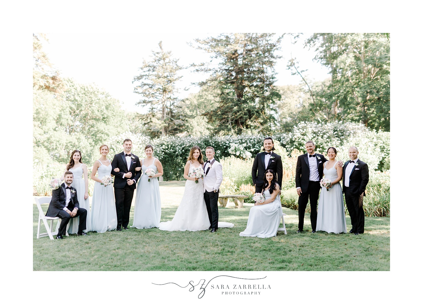 newlyweds pose in between wedding party at Glen Manor House