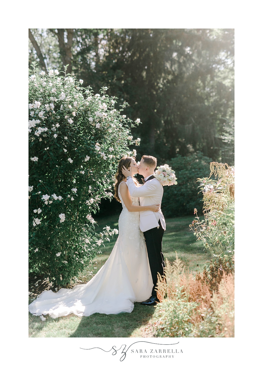 bride and groom kiss in gardens at Glen Manor House