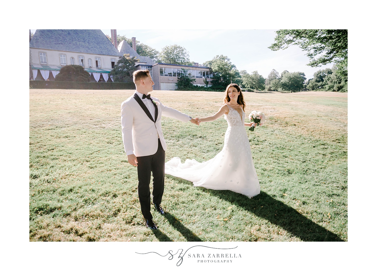 newlyweds hold hands walking on grounds at Glen Manor House
