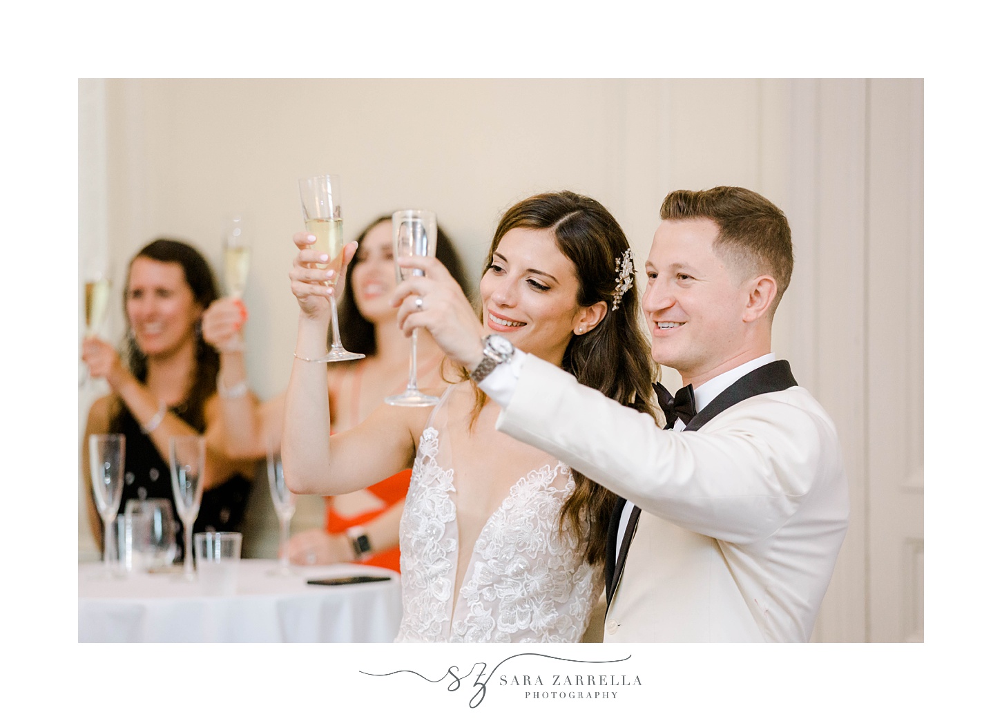 couple lifts glasses of champagne during Portsmouth RI wedding reception