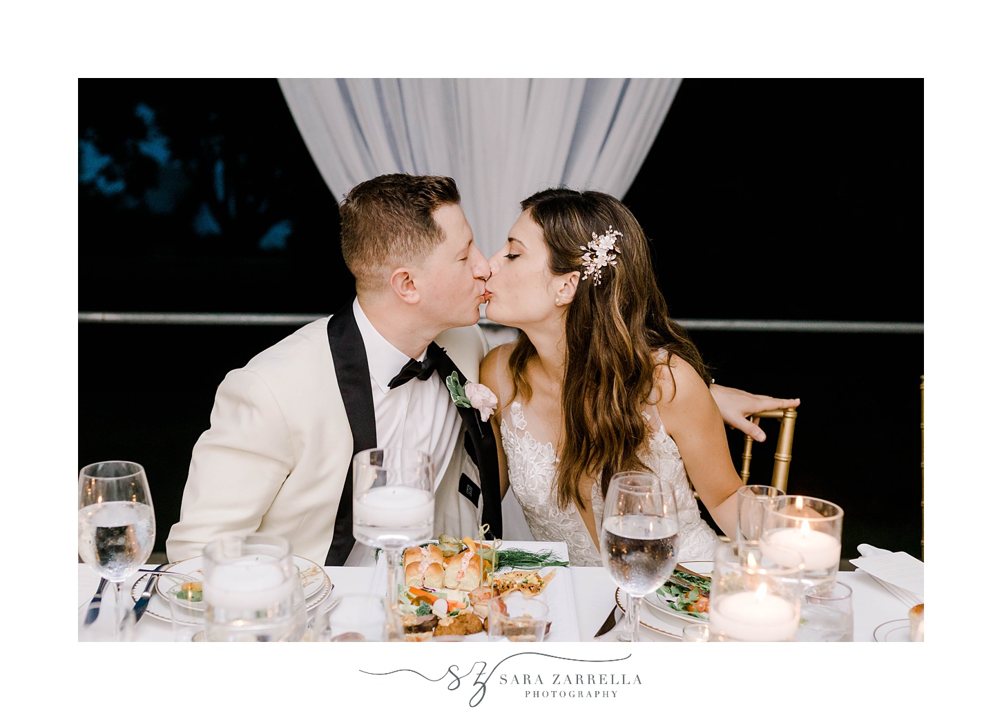  newlyweds kiss at sweetheart table 