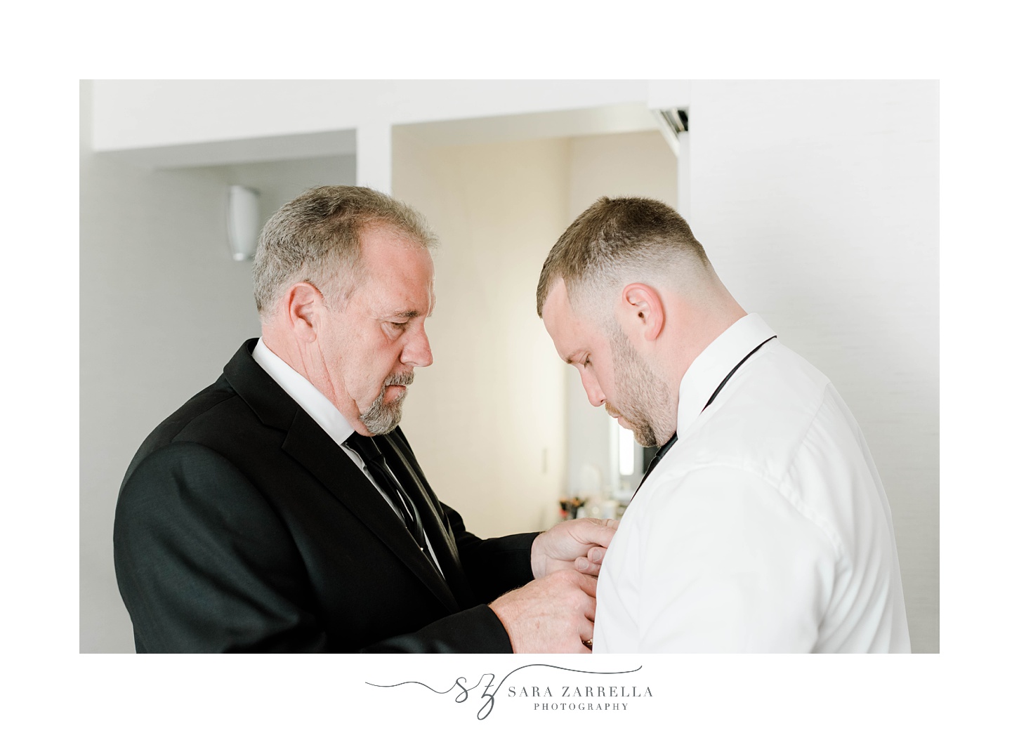 dad helps groom with tie before RI wedding day