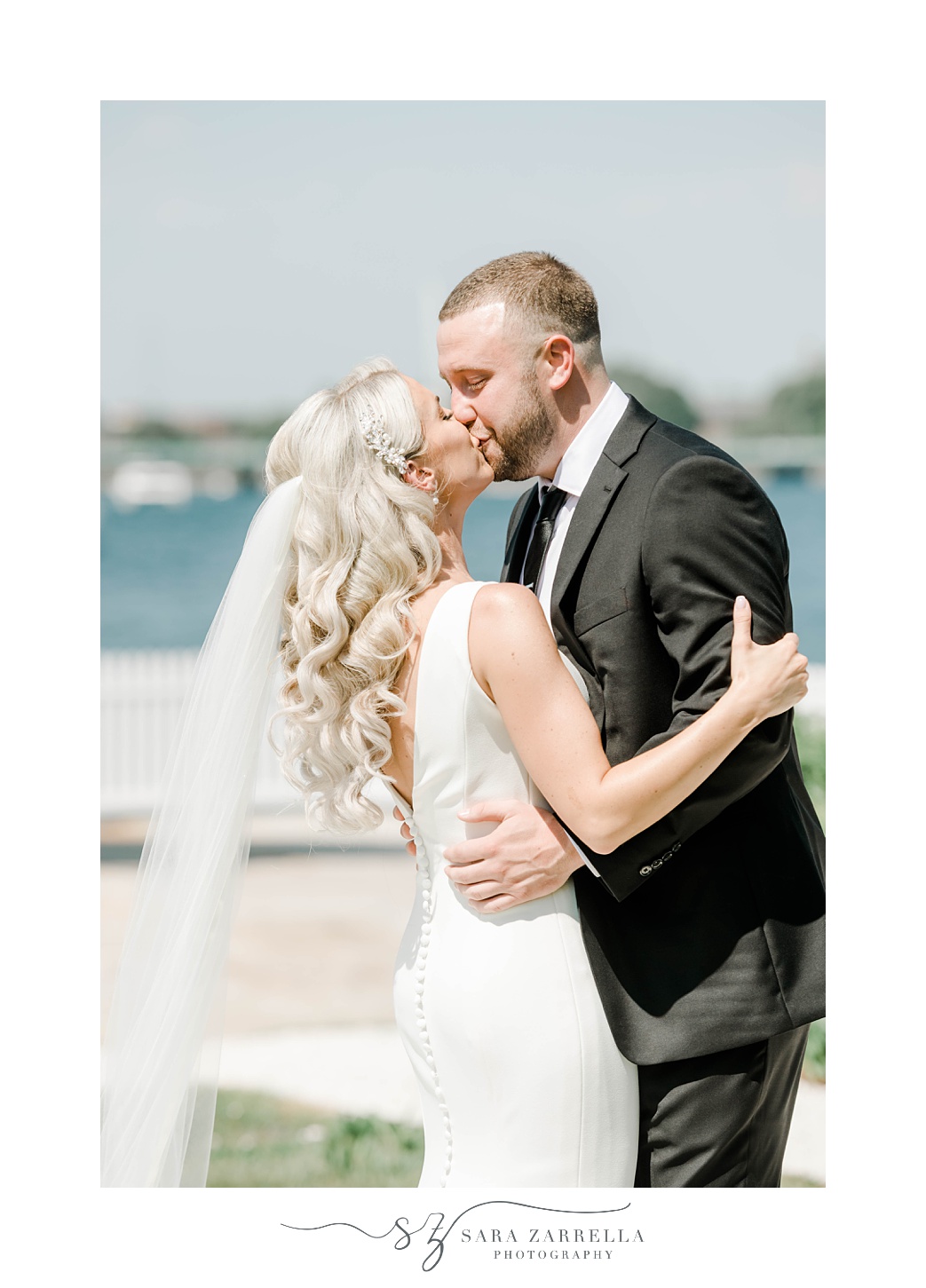 bride and groom kiss by Bay at Gurney’s Newport Resort