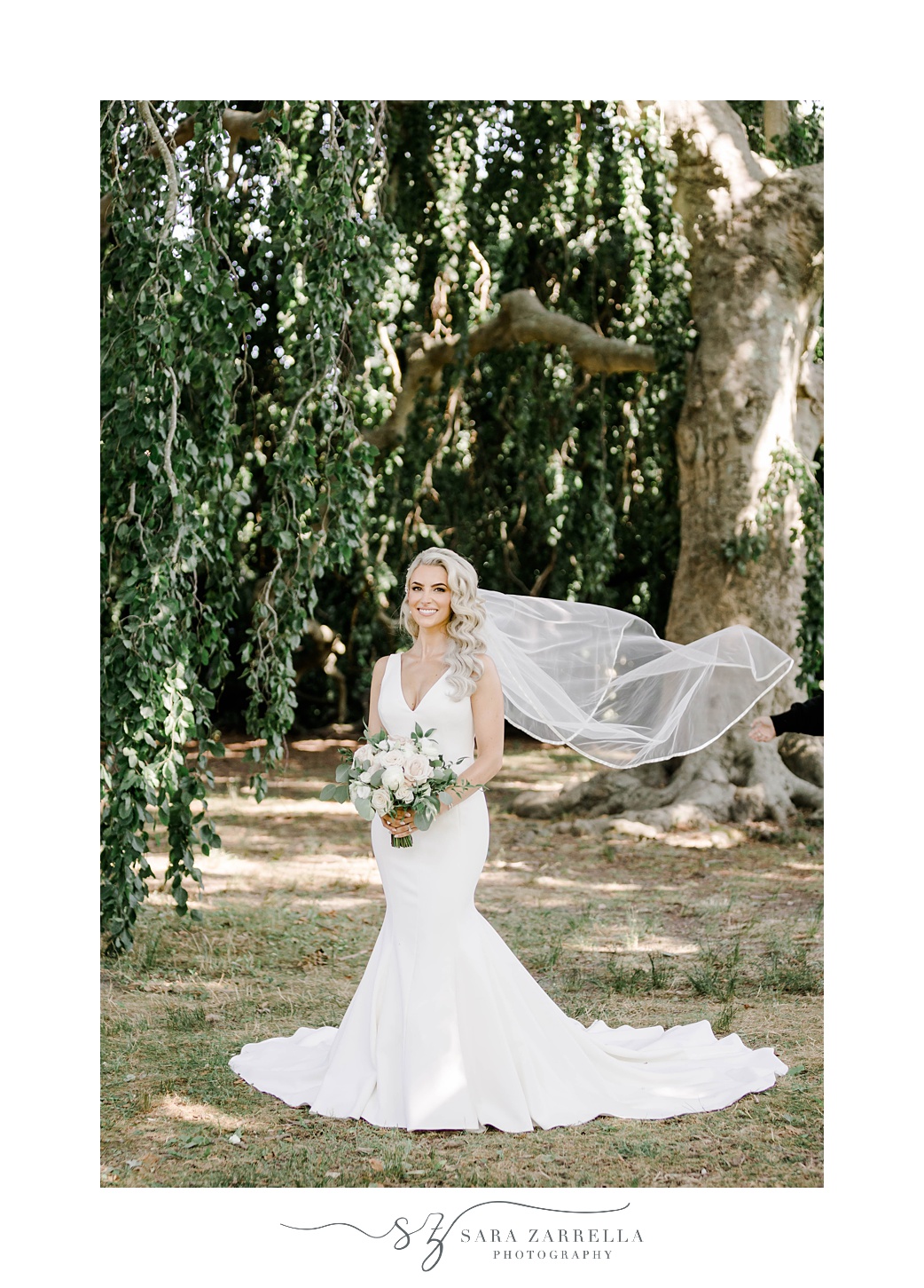 bride stands with veil floating behind her at The Elms