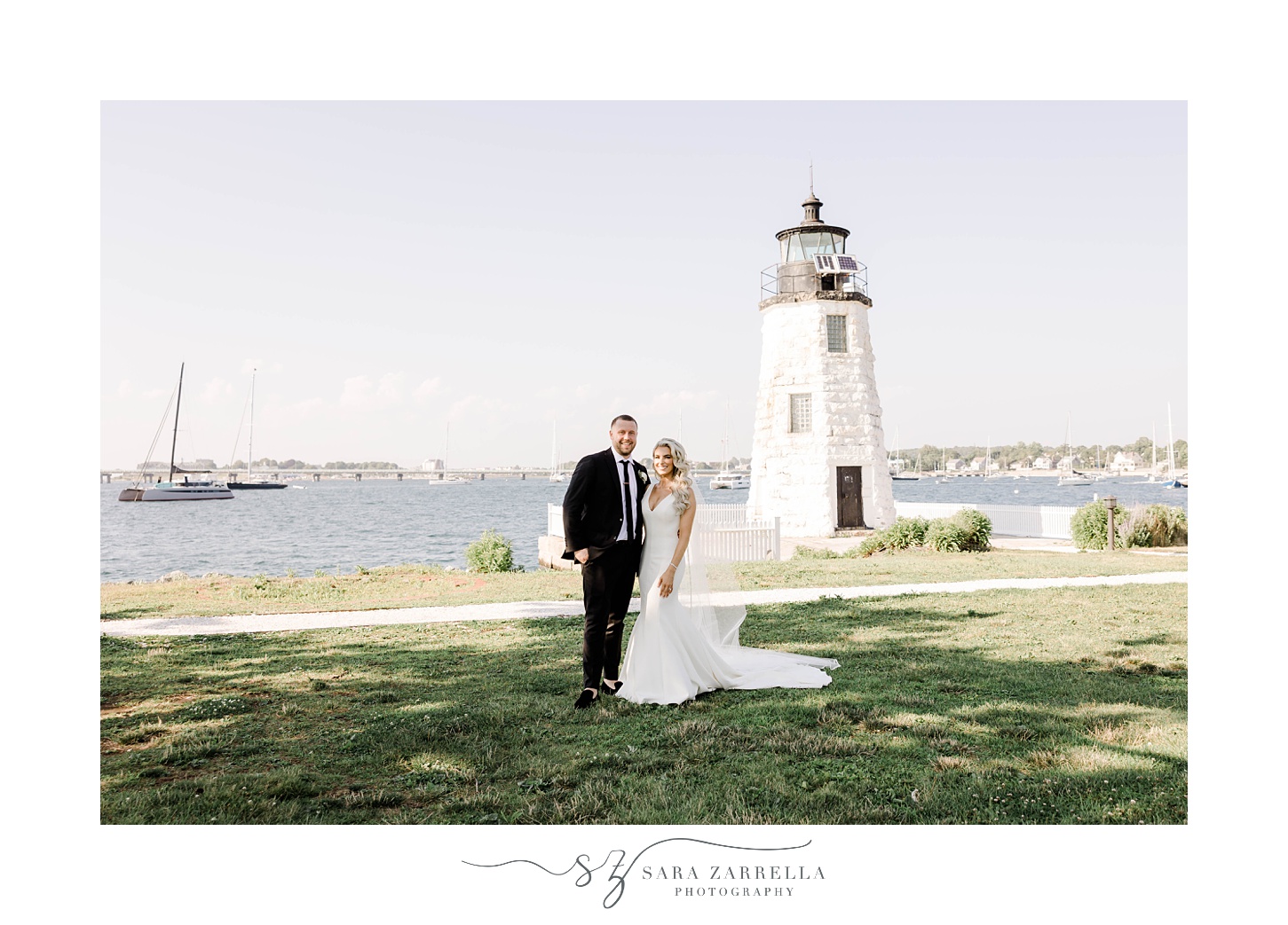 bride and groom hug by Newport Lighthouse 