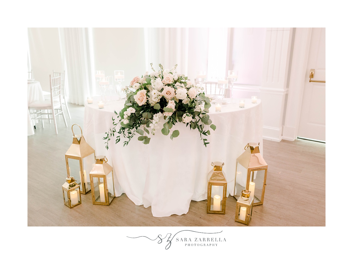 sweetheart table with lanterns and greenery 