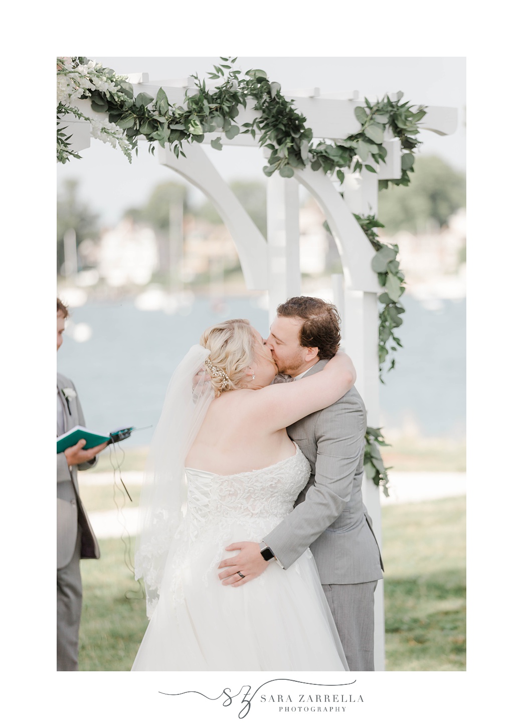 bride and groom kiss during wedding ceremony at Gurney’s Newport