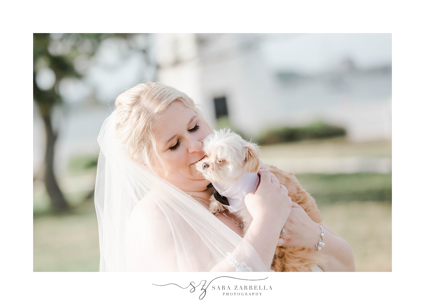 bride kisses dog on cheek during wedding day at Gurney’s Newport