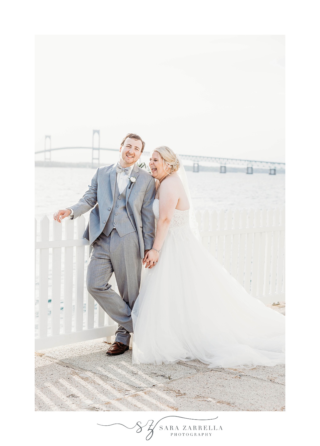 bride laughs standing with groom at Gurney’s Newport