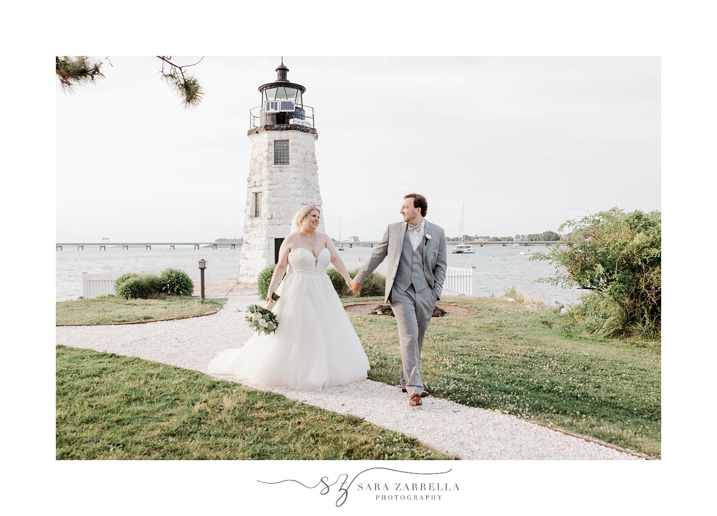 newlyweds walk outside Gurney’s Newport by lighthouse 