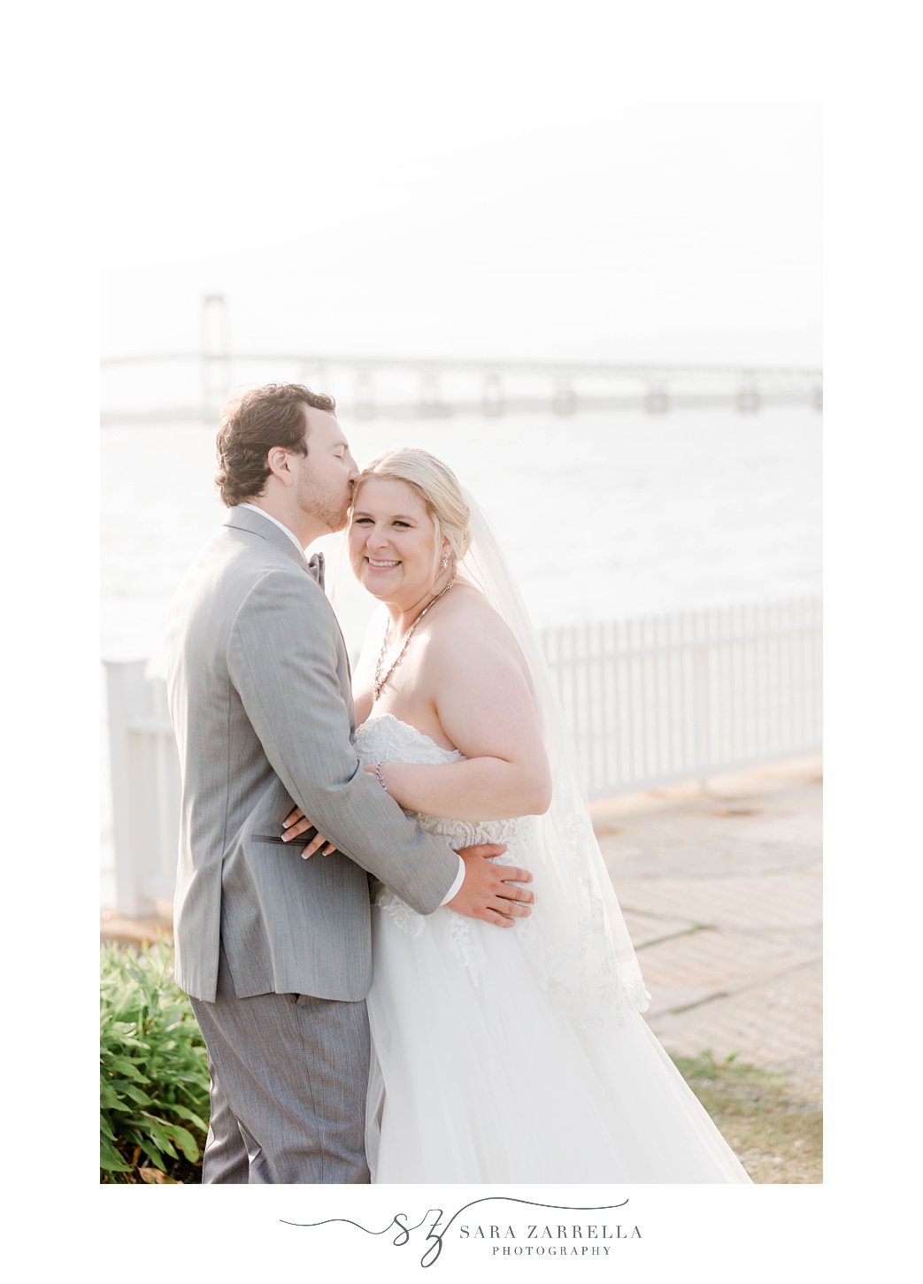groom kisses bride's forehead in Newport RI