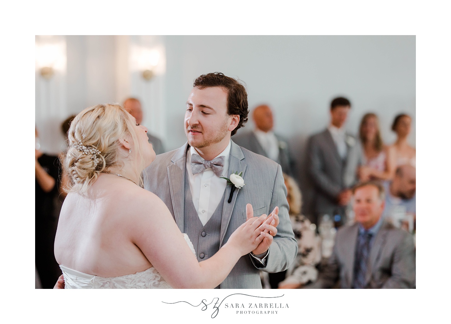 groom smiles at bride during first dance in Newport RI