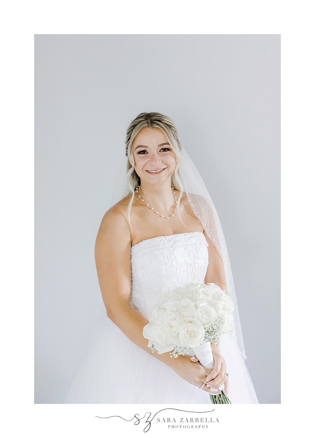 bride smiles in strapless gown