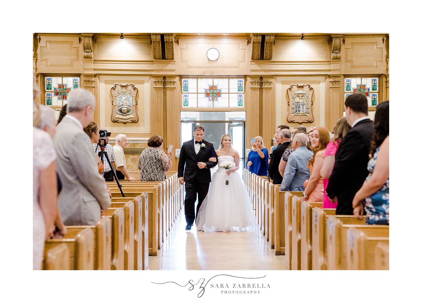 bride walks down aisle with dad for Catholic church wedding ceremony in Rhode Island