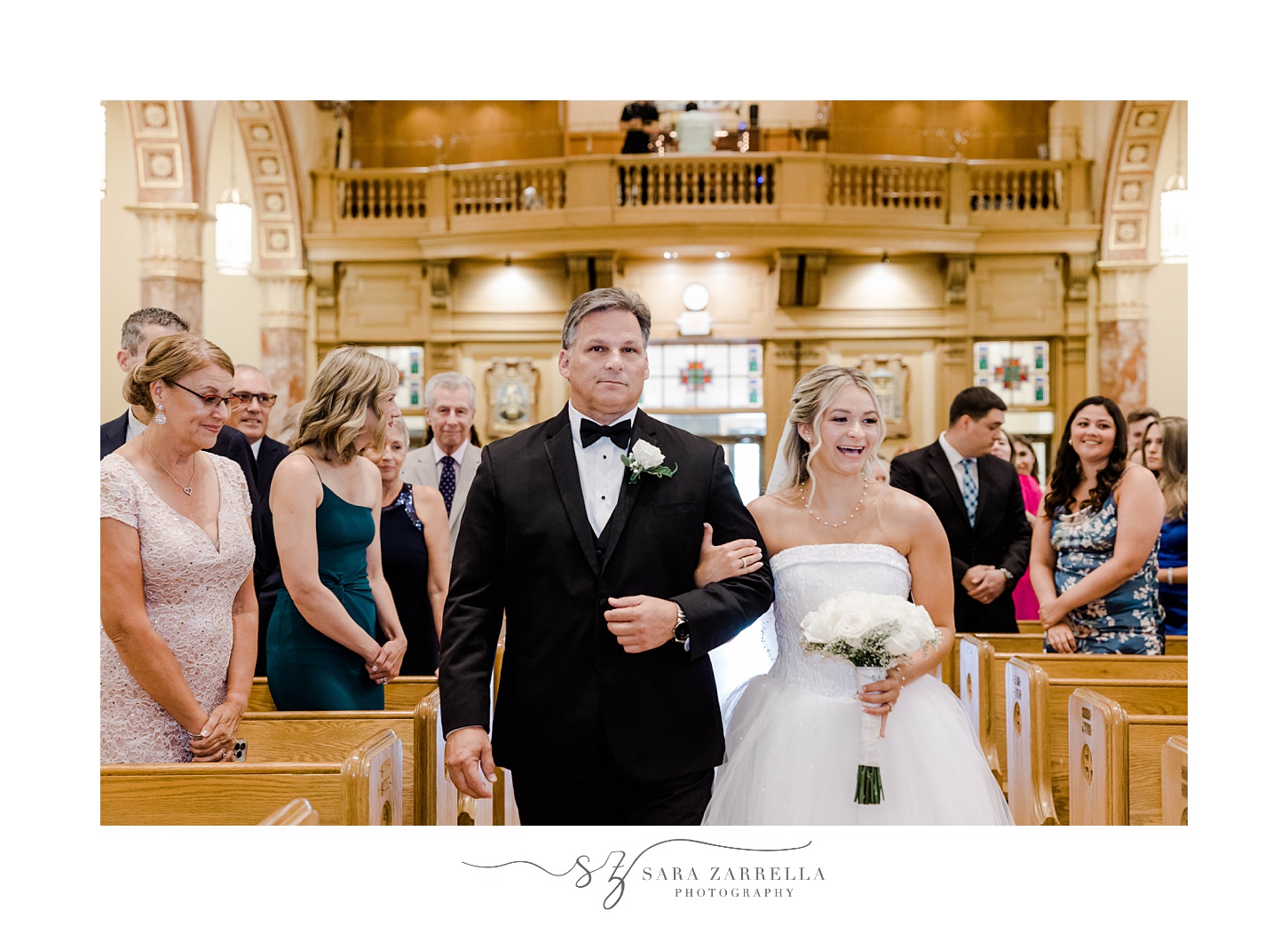 bride and dad enter Catholic church wedding ceremony in Rhode Island