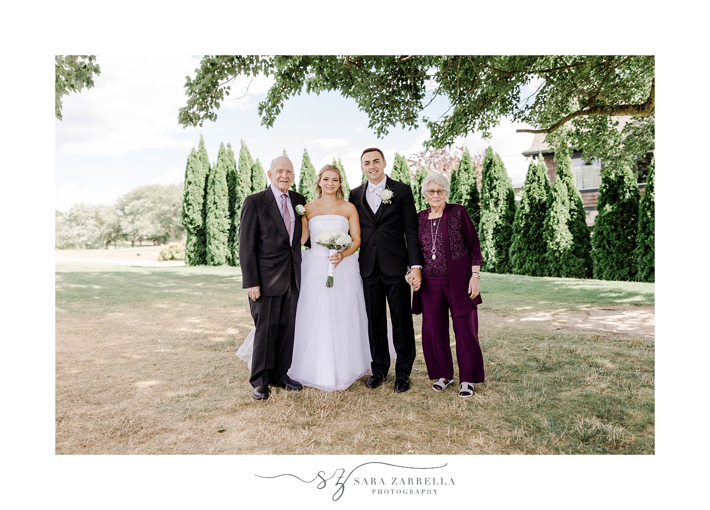 bride and groom pose with grandparents