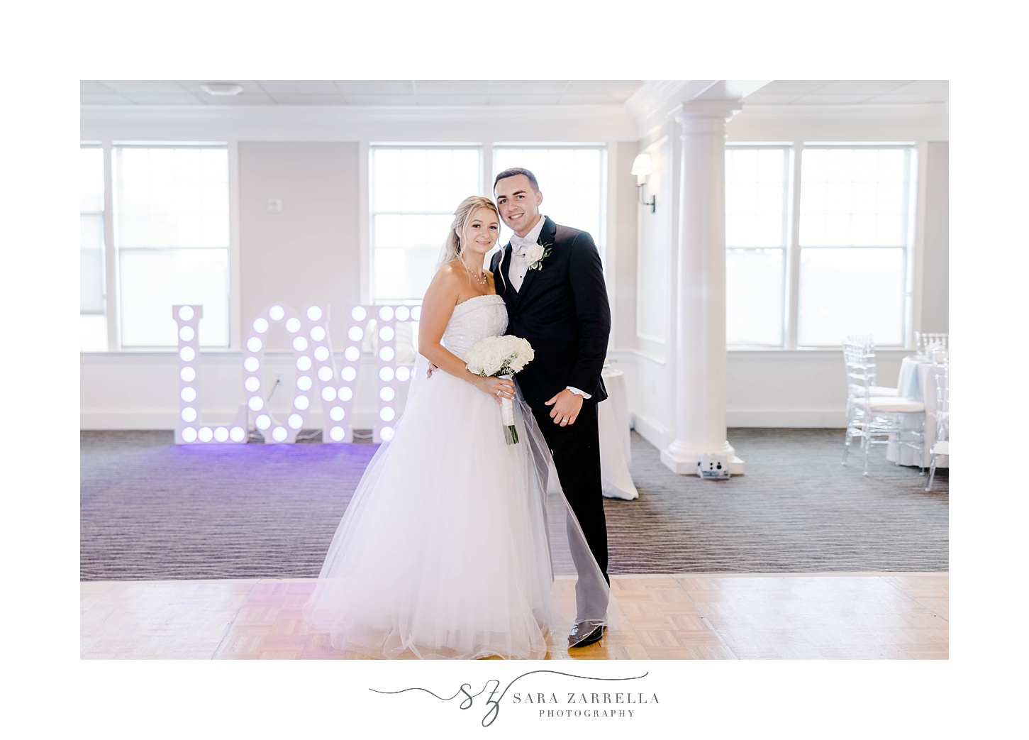 bride and groom stand by LOVE marquee at Warwick RI wedding reception
