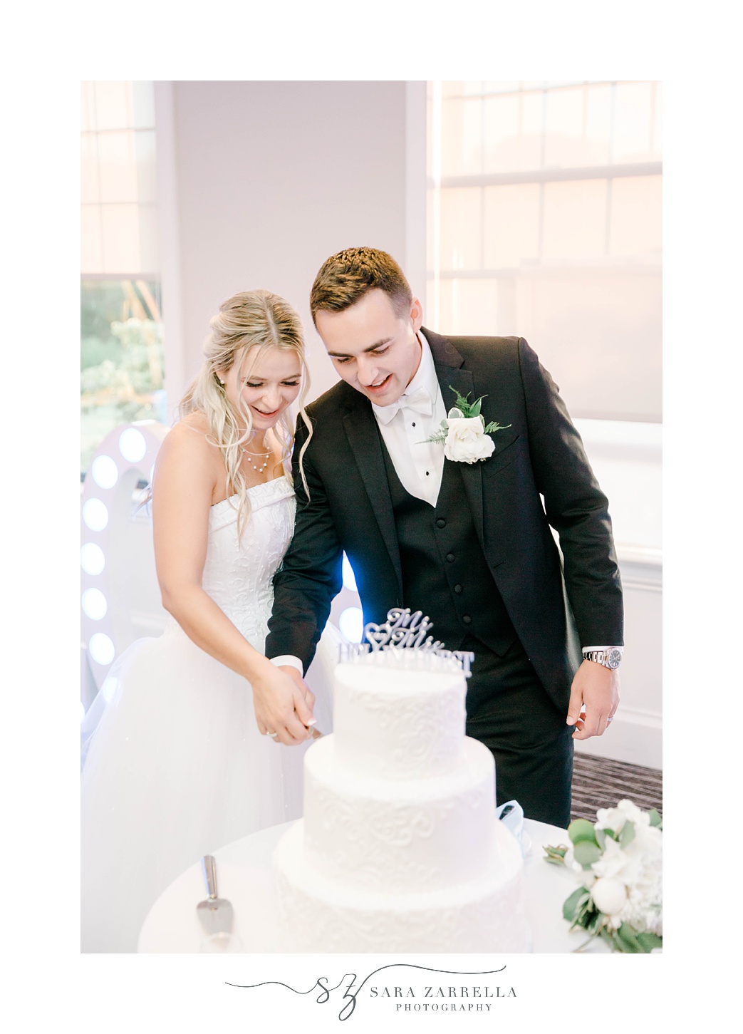 newlyweds cut wedding cake during Warwick RI wedding reception